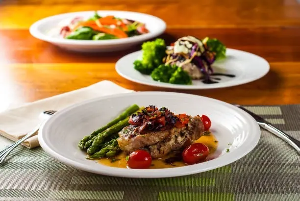 Plated fish entrée prepared by The Garden of E’tin